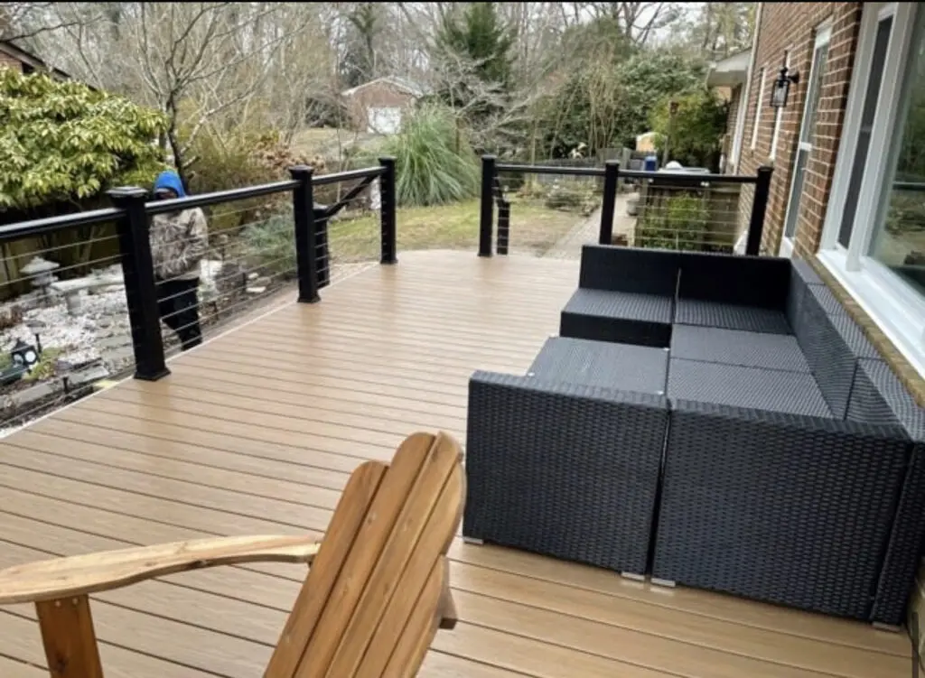 A deck with chairs and a couch on it